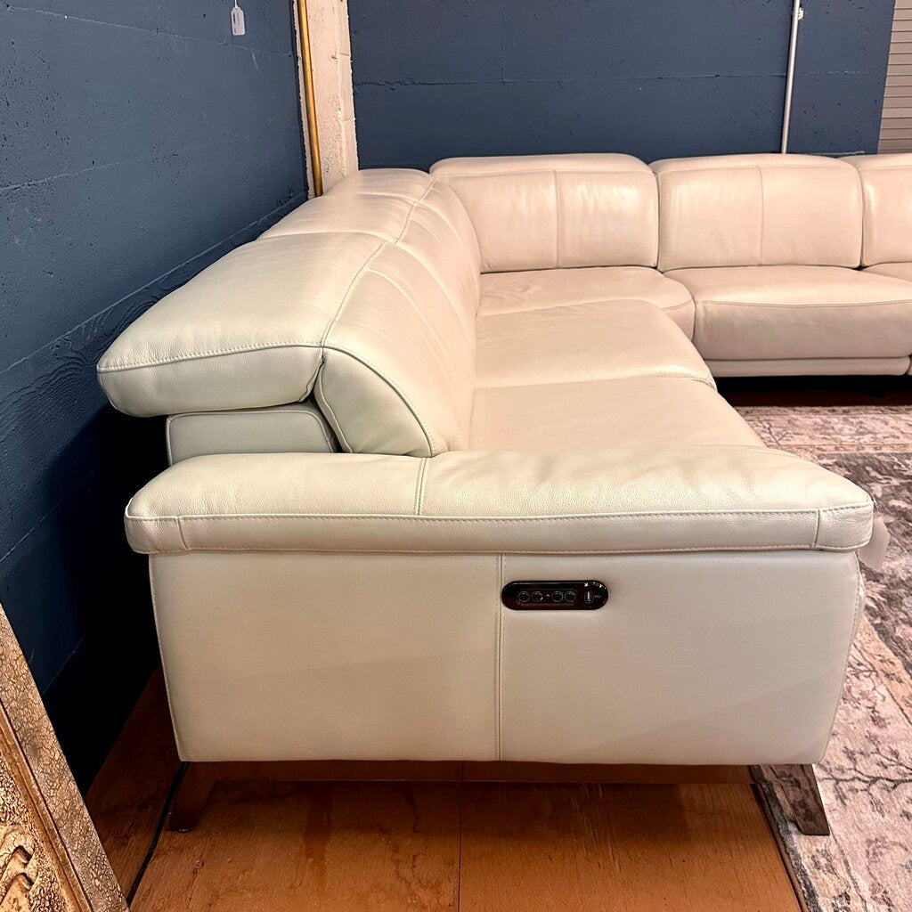 White sectional sofa against a blue wall