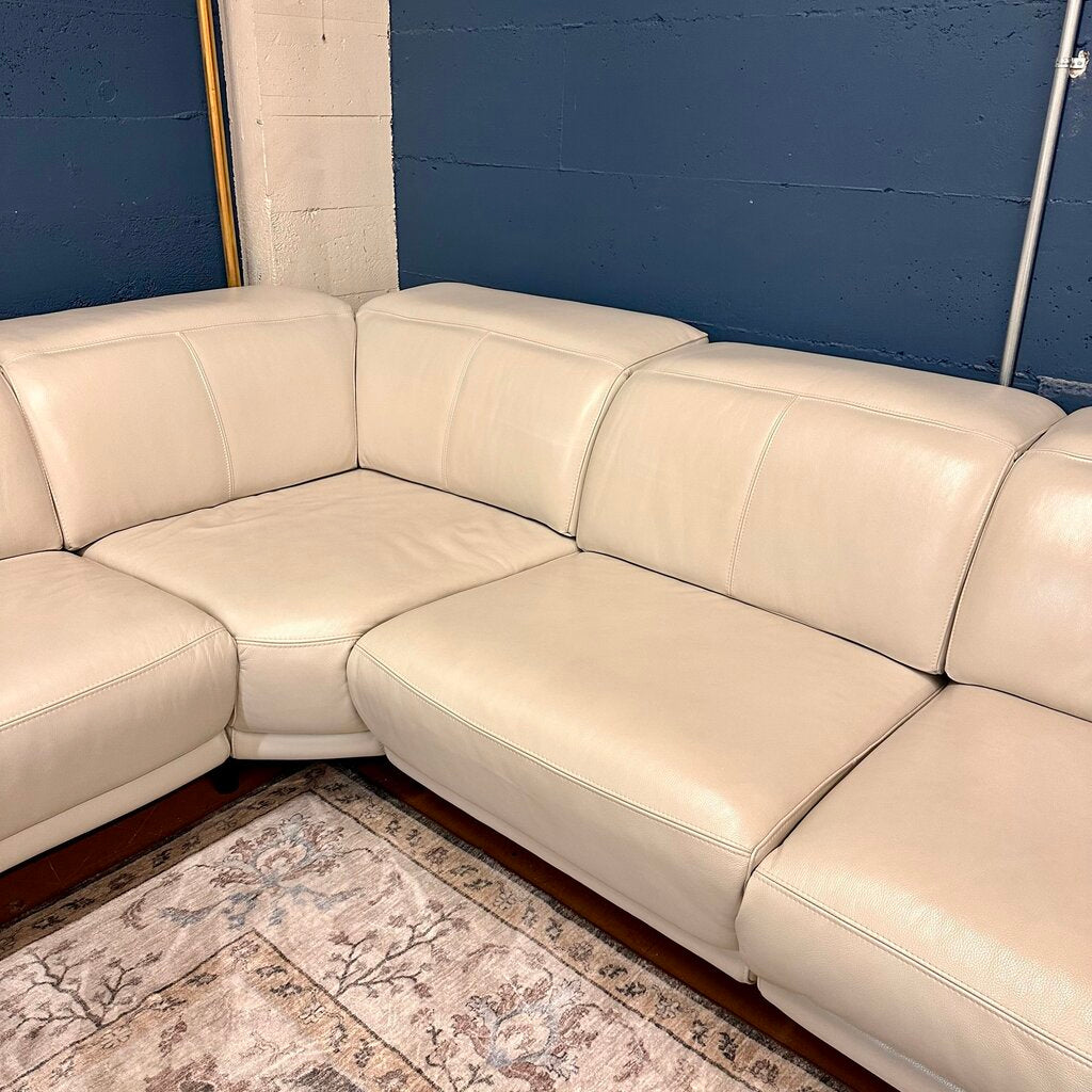 Beige sectional sofa against a blue wall
