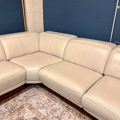 Beige sectional sofa against a blue wall