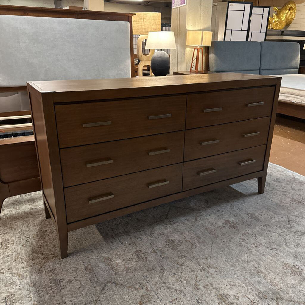 Wooden dresser with multiple drawers in a room setting