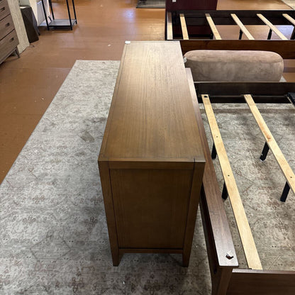 Wooden desk in a room with furniture and flooring visible
