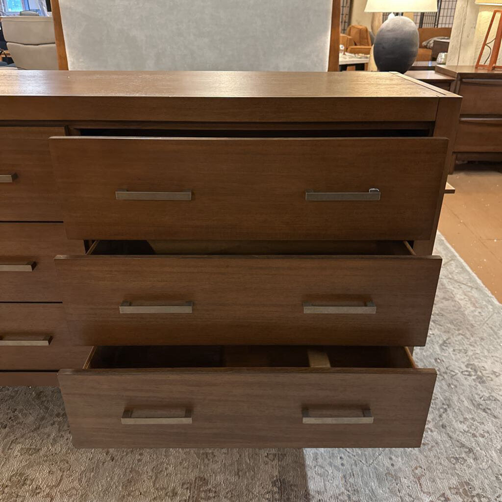 Wooden dresser with multiple drawers in a room setting