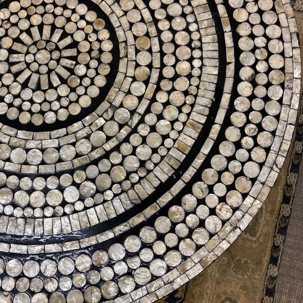 Close-up of a circular stone mosaic pattern