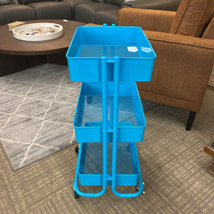 Blue three-tier rolling cart in a living room setting