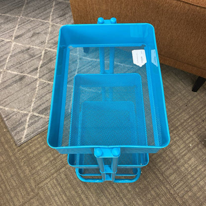 Blue mesh storage cart on a carpeted floor with a brown couch in the background