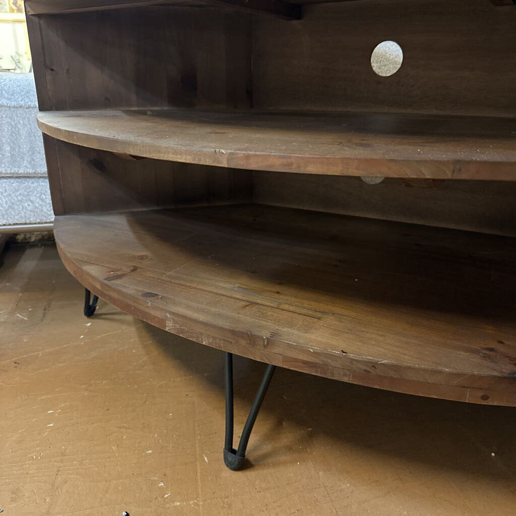 Wooden shelf with metal legs on a wooden floor