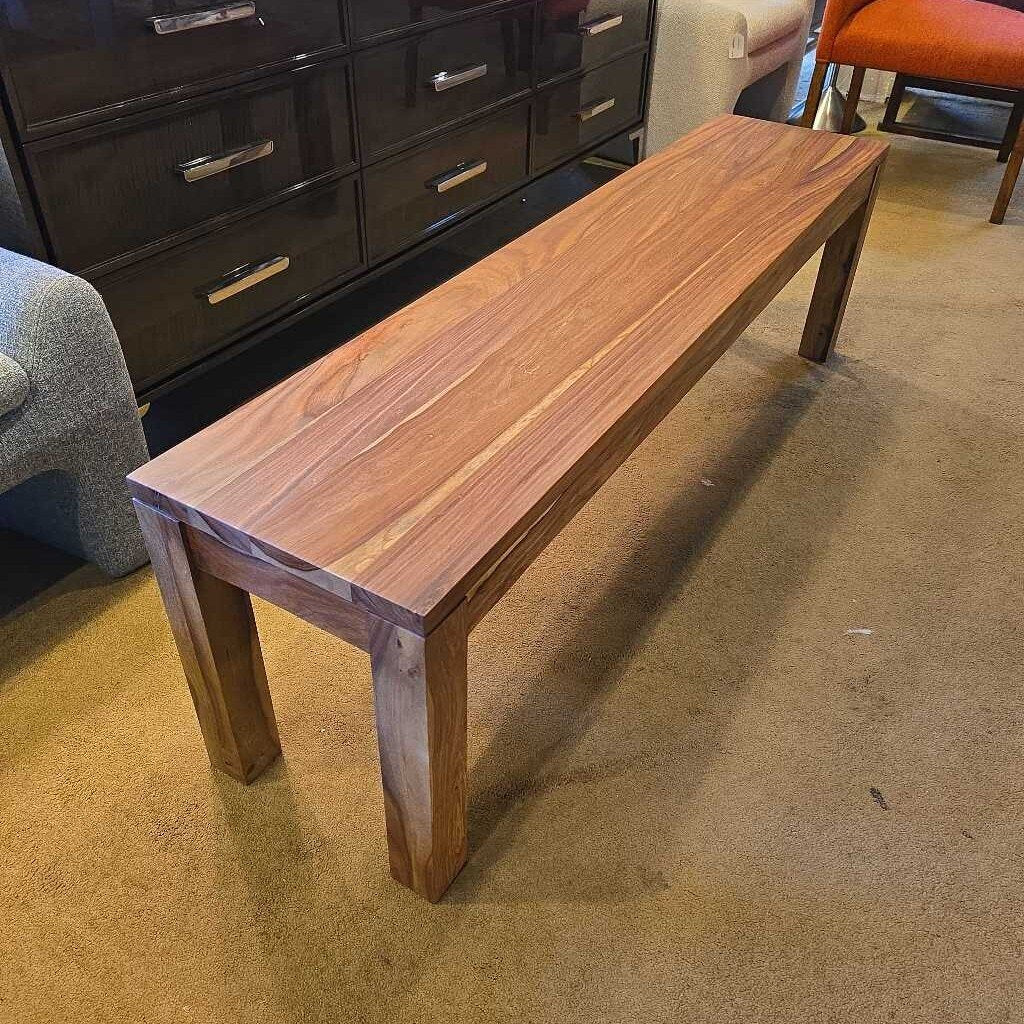 A long, rectangular solid wood bench with a waterfall-style top and thick, square legs, showcasing a vibrant natural wood grain.
