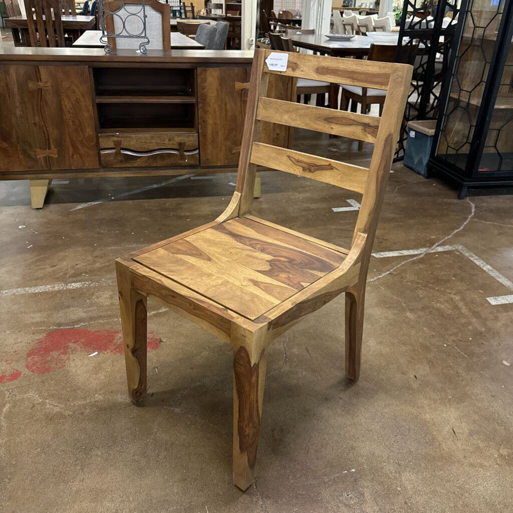Wooden chair on a concrete floor with a blurred background