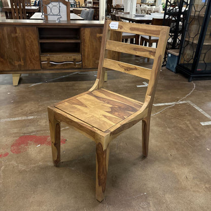 Wooden chair on a concrete floor with a blurred background