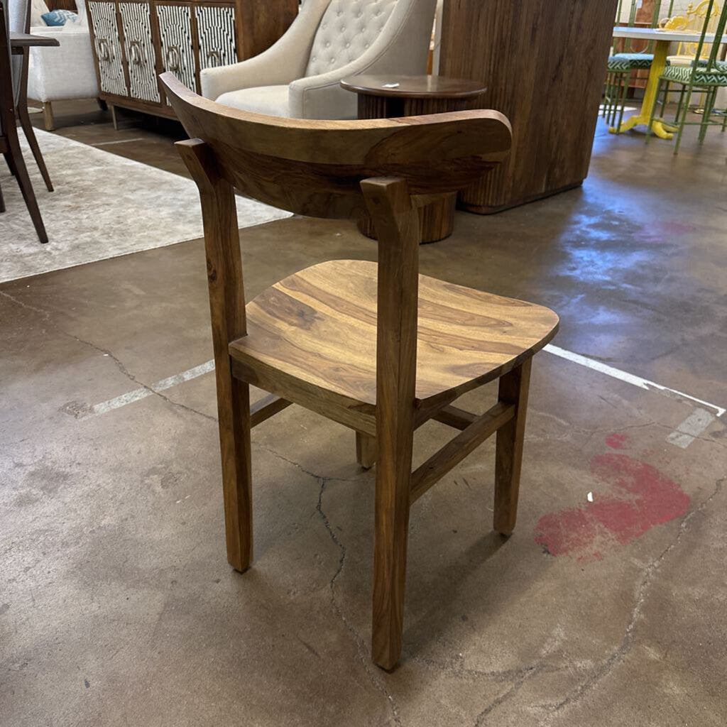 Wooden chair on a concrete floor with blurred background