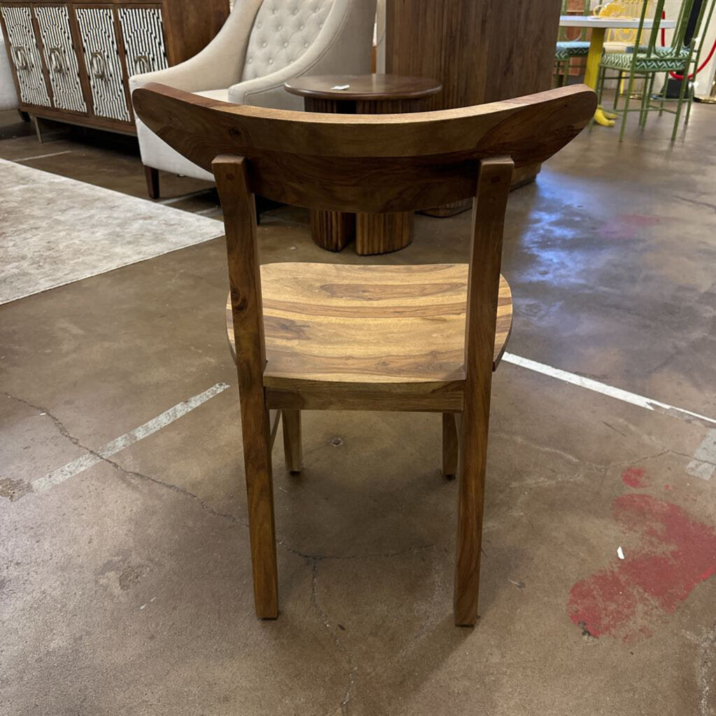 Wooden chair on a concrete floor with a blurred background