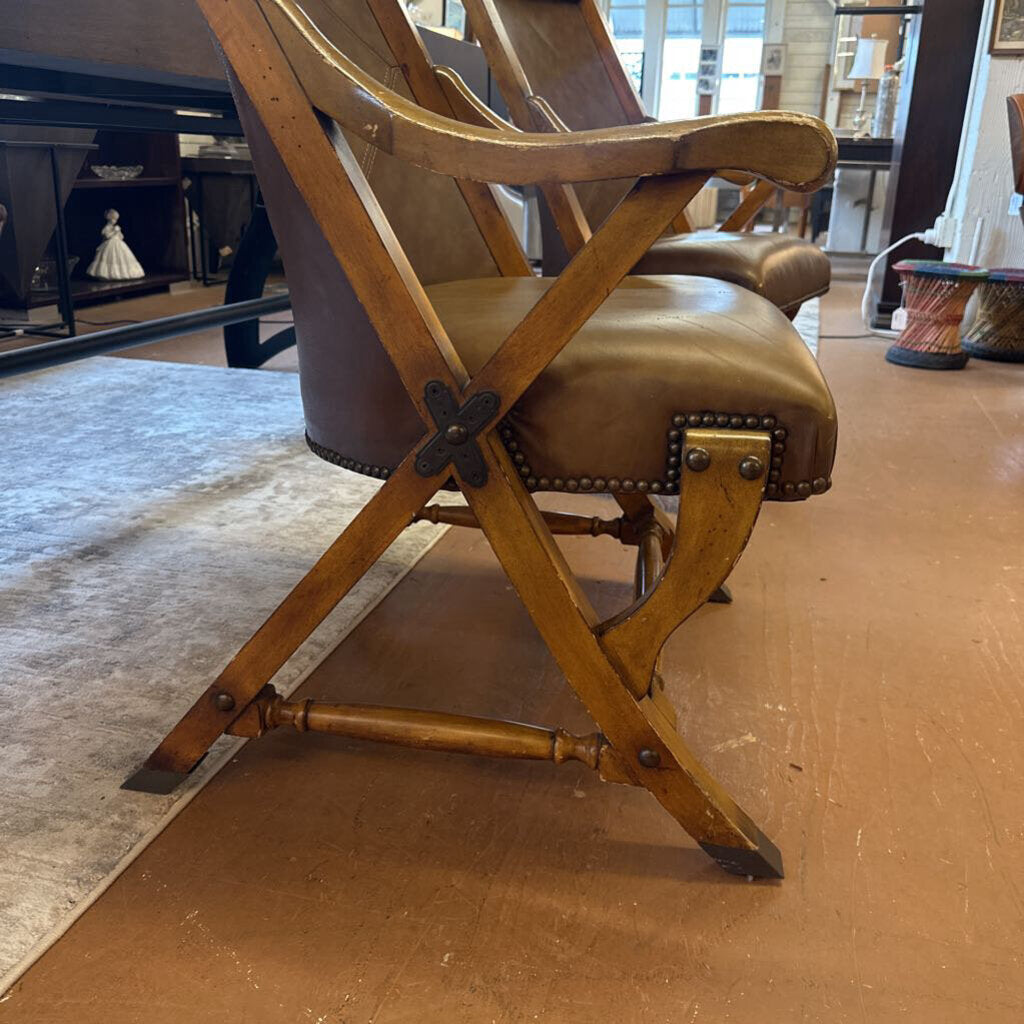 Wooden and leather armchair in a room with a rug and piano.