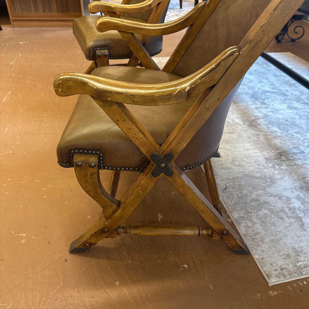Wooden chair with leather seat on a wooden floor