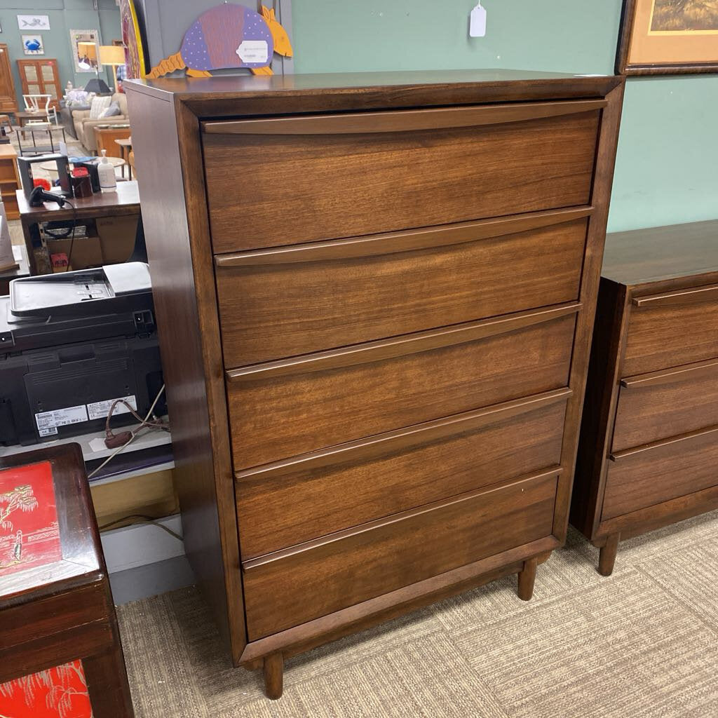 Wooden dresser with multiple drawers in a room setting