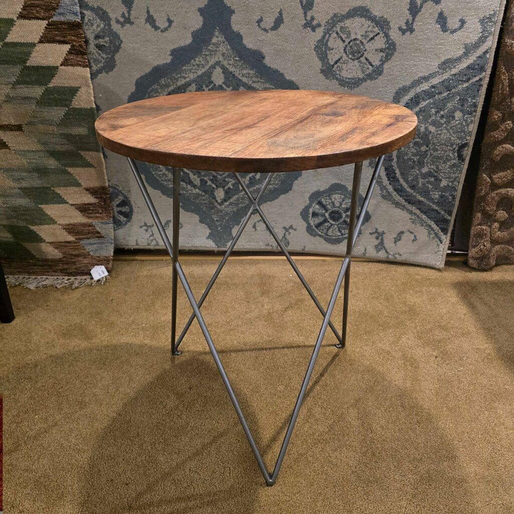 Wooden side table with metal legs against a patterned rug
