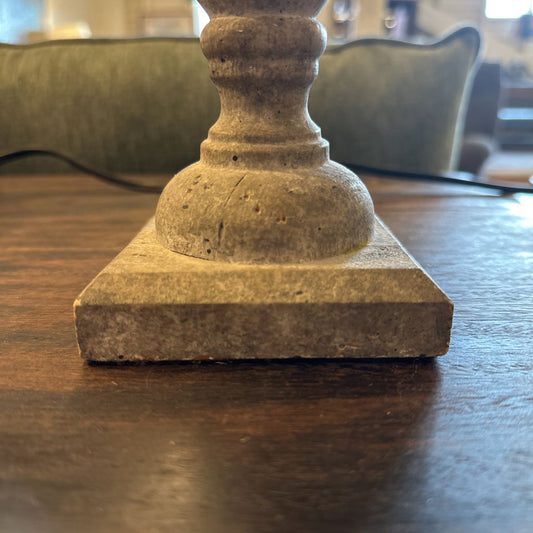 Decorative stone candle holder on a wooden surface