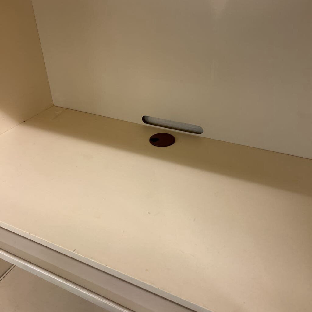 Beige countertop with a small hole and metallic strip