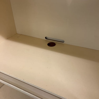 Beige countertop with a small hole and metallic strip