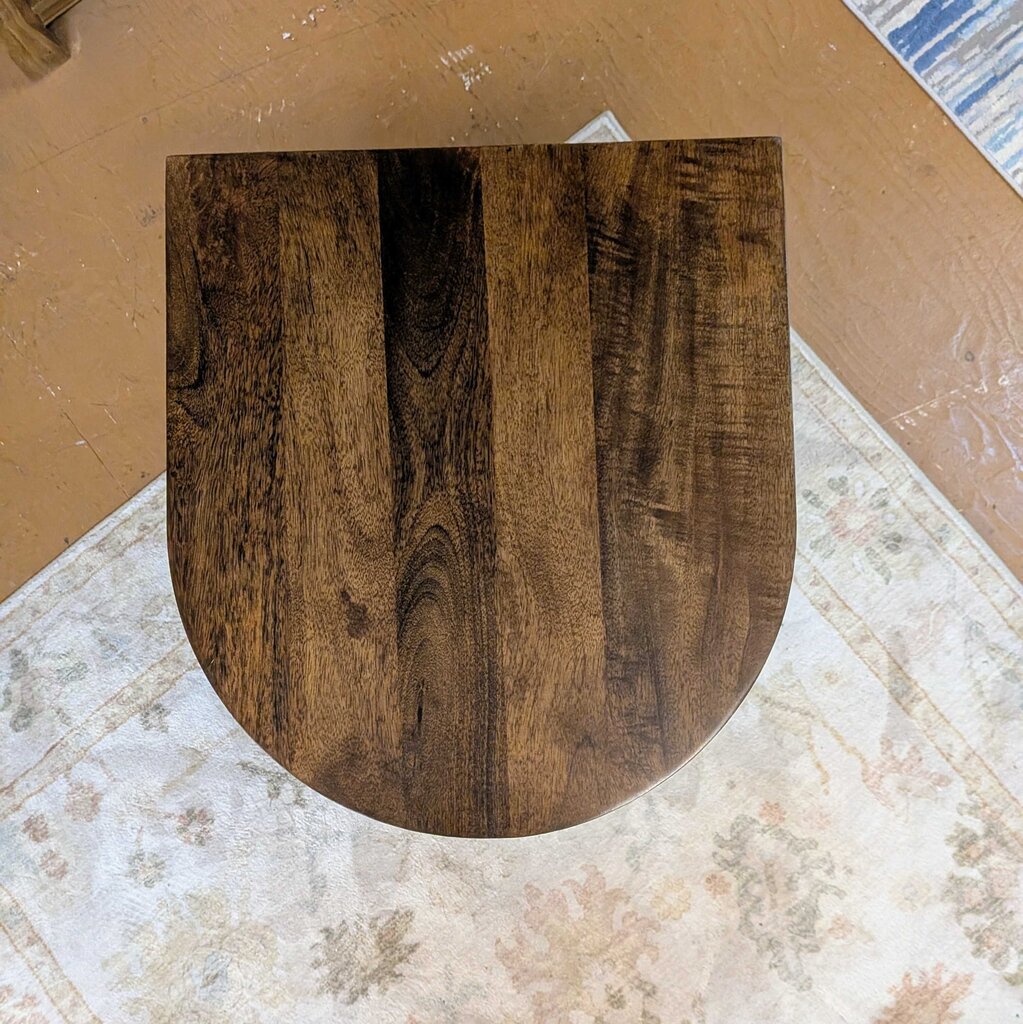 Wooden toilet seat on a tiled floor
