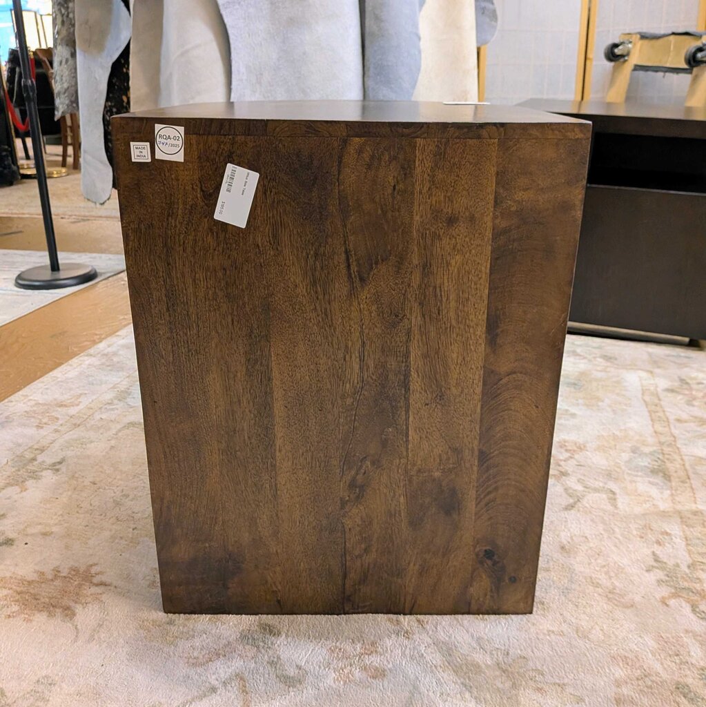 Wooden pedestal with price tags on a marble floor