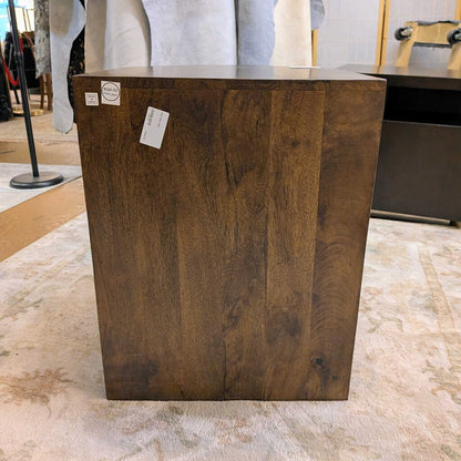 Wooden pedestal with price tags on a marble floor