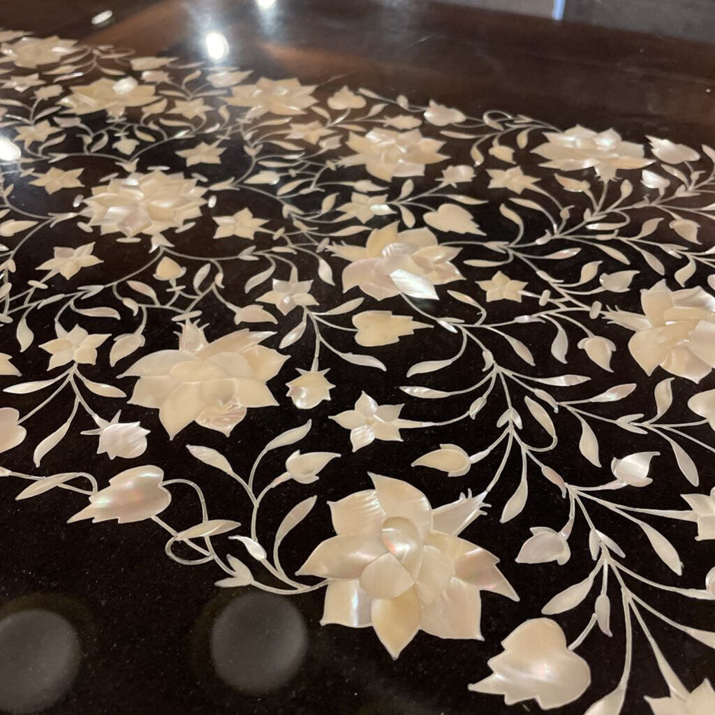 Decorative surface with white floral patterns on a dark background