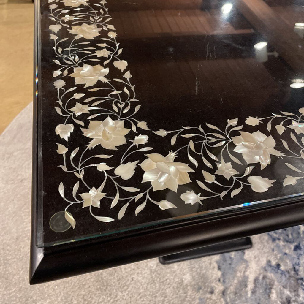 Decorative black surface with white floral patterns