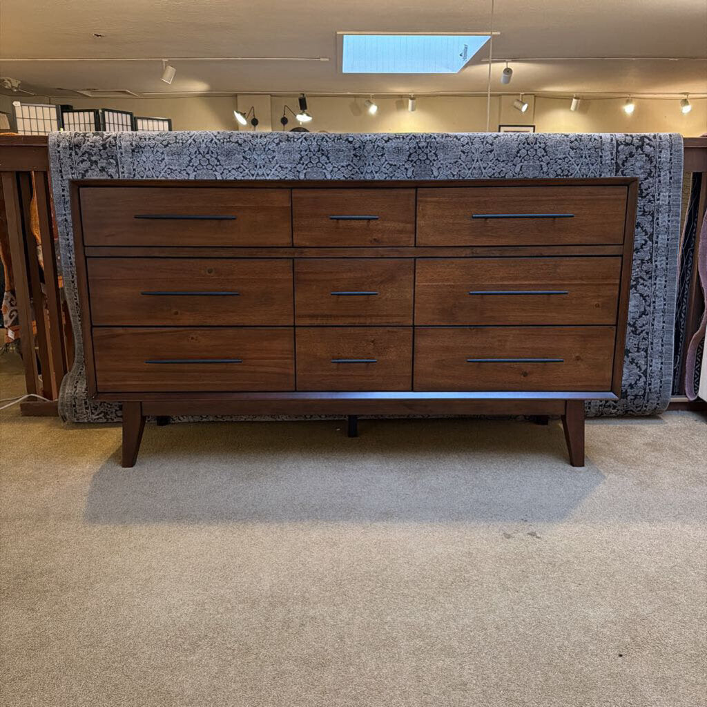 Wooden dresser with marble countertop in a showroom setting