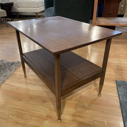 Wooden side table with a shelf on a wooden floor