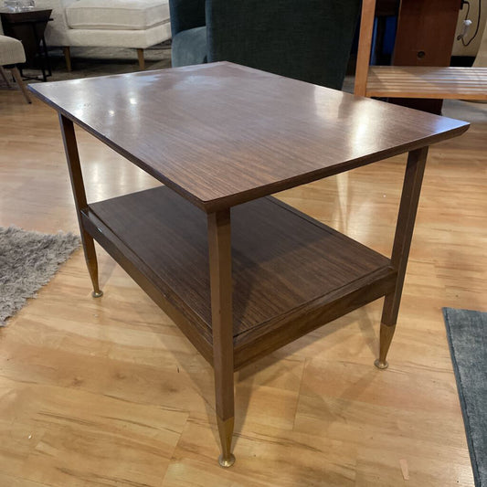 Wooden side table with a shelf on a wooden floor
