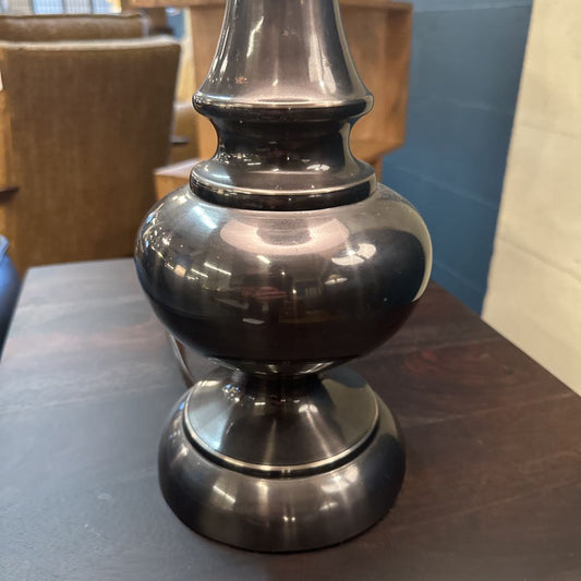 Silver lamp on a wooden table with a blurred background