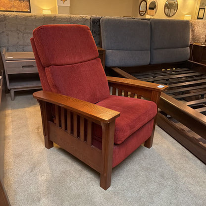 Red armchair with wooden frame in a showroom setting