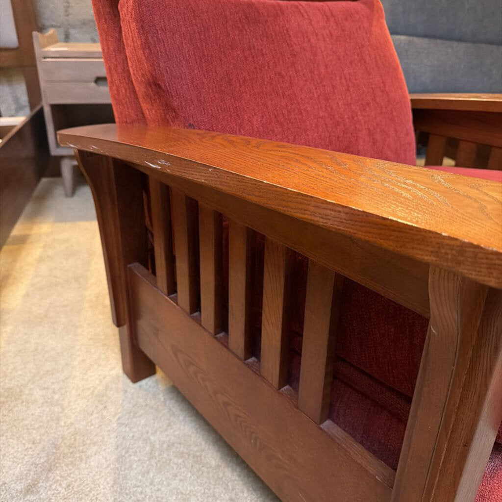 Wooden radiator cover with red cushion on a gray carpet
