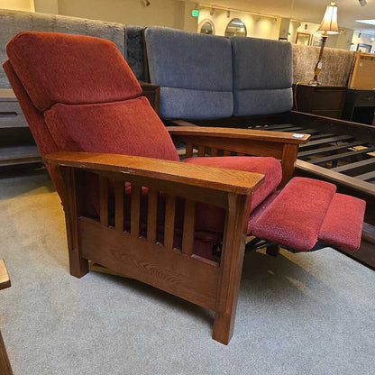 Red recliner chair with wooden frame in a furniture store setting