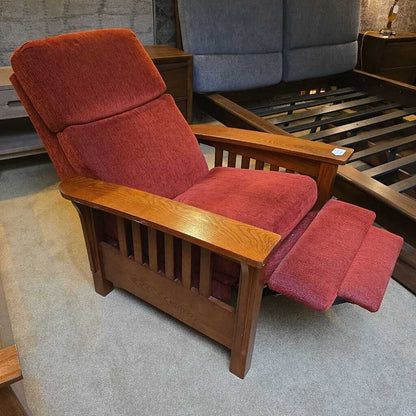 Red recliner chair with wooden frame on a gray floor