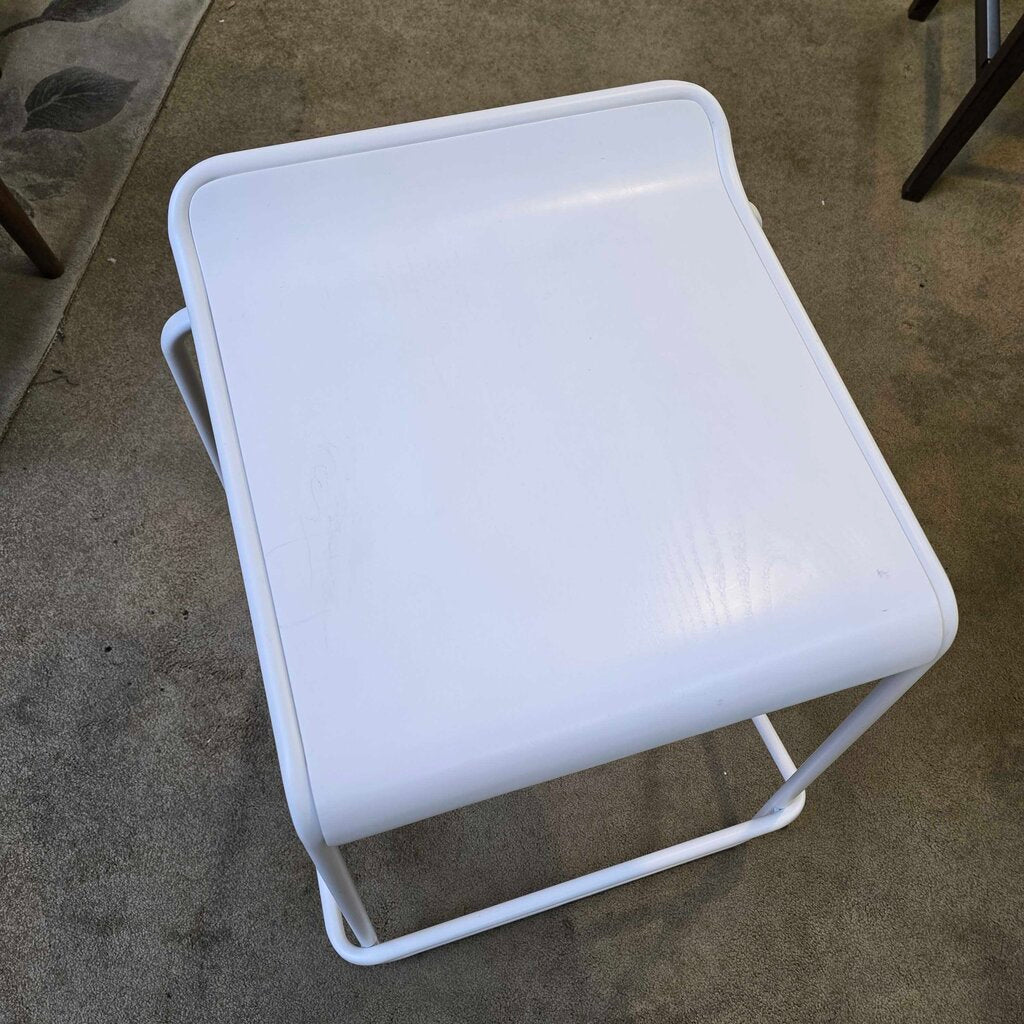 White stool on a concrete floor