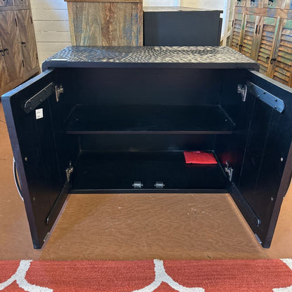Black metal safe with open door on a wooden floor