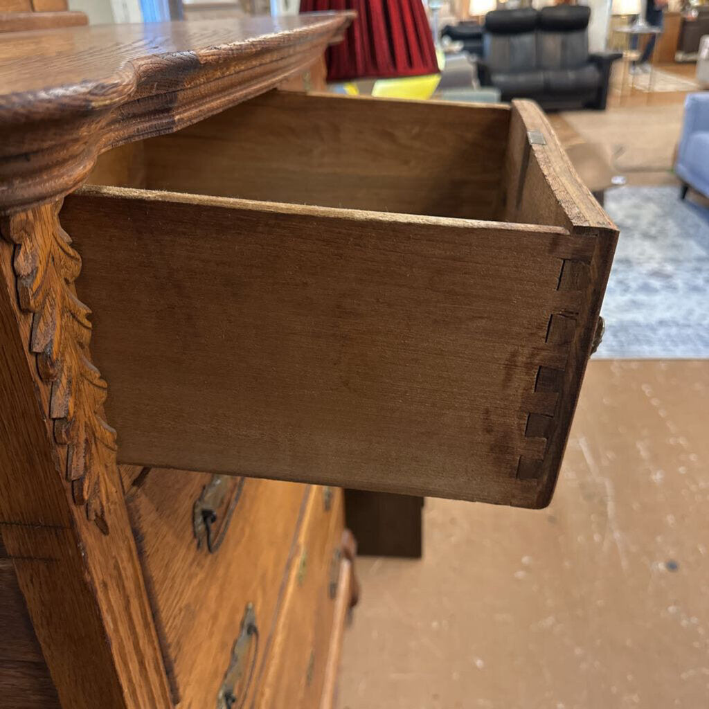 Wooden drawer being pulled out from a piece of furniture with a blurred indoor background.
