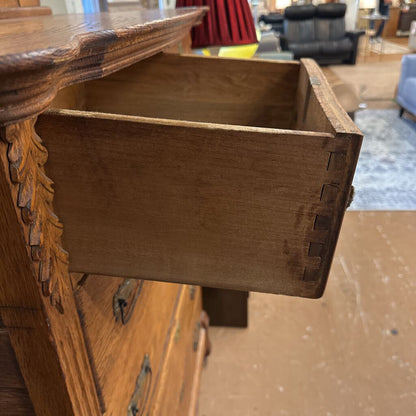 Wooden drawer being pulled out from a piece of furniture with a blurred indoor background.