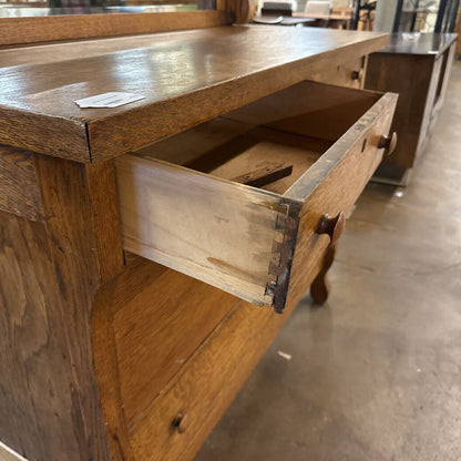 Wooden drawer of a vintage piece of furniture with a worn surface.