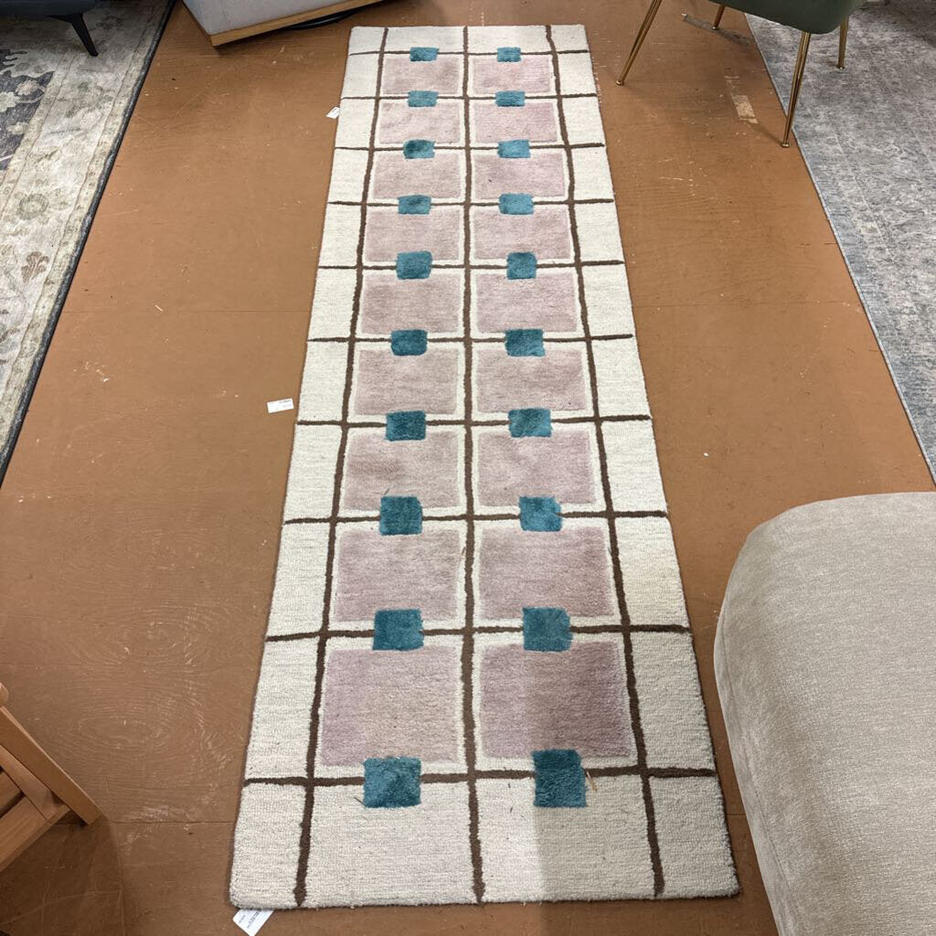 Geometric patterned rug on a cardboard floor