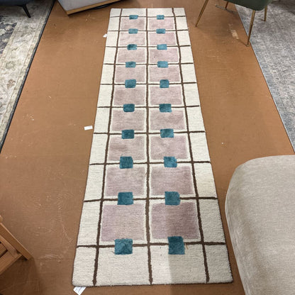 Geometric patterned rug on a cardboard floor