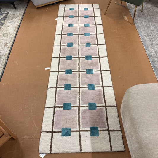 Geometric patterned rug on a cardboard floor