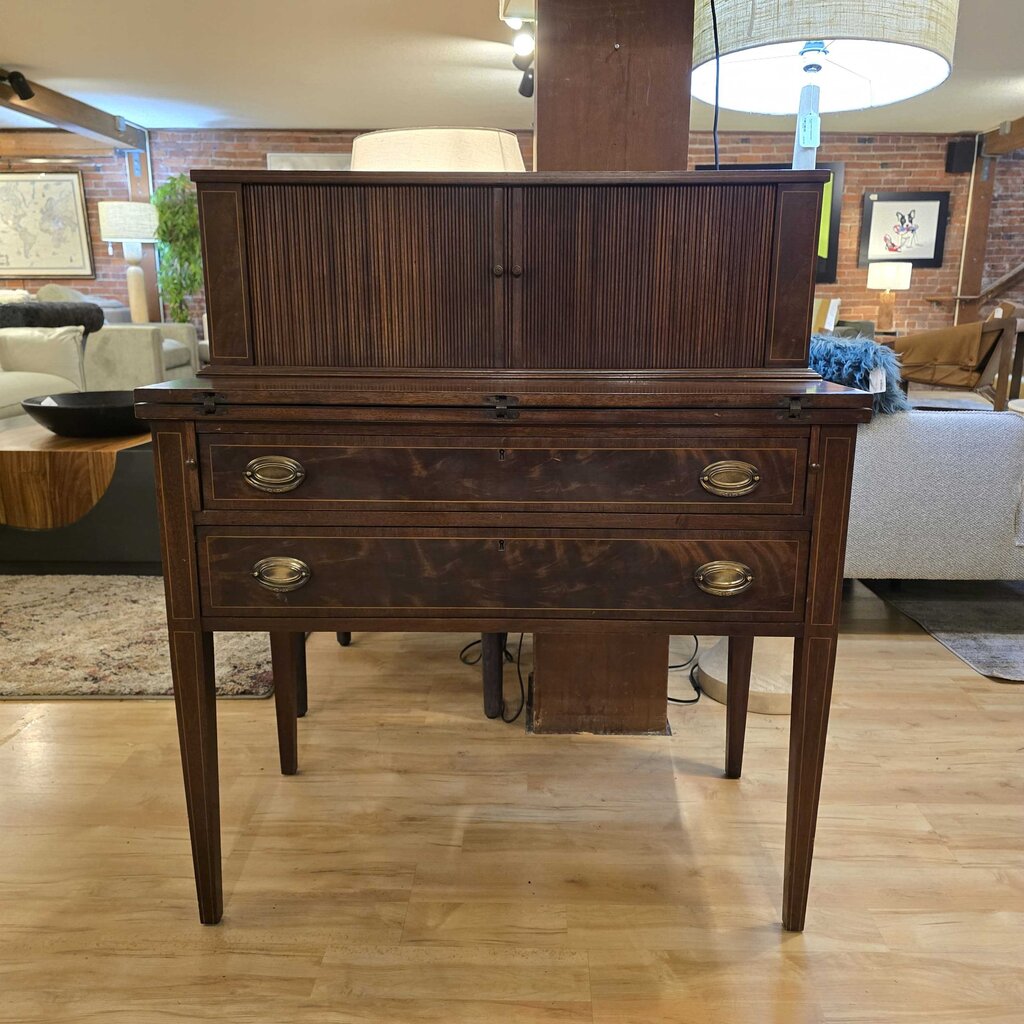 Wooden dresser in a living room setting with furniture and decor.