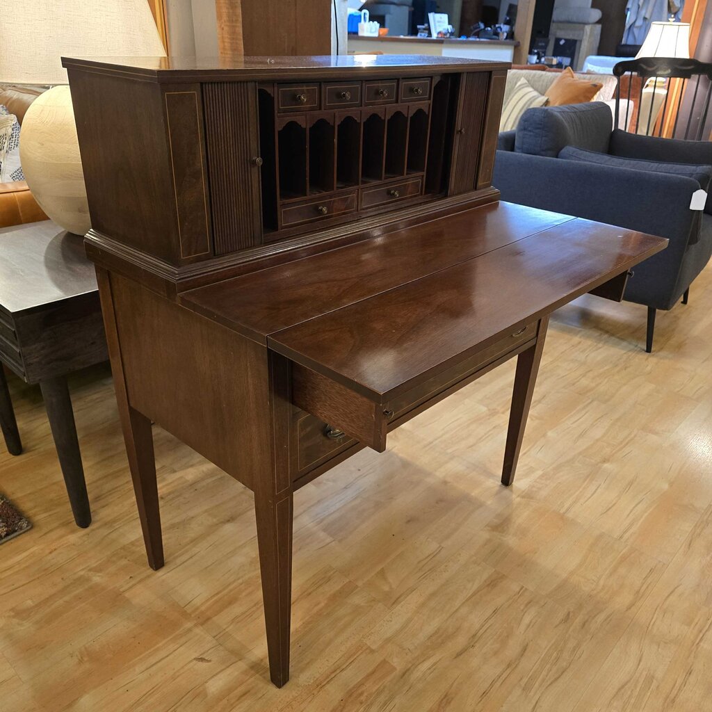 Wooden desk with cabinet in a room with furniture and decor