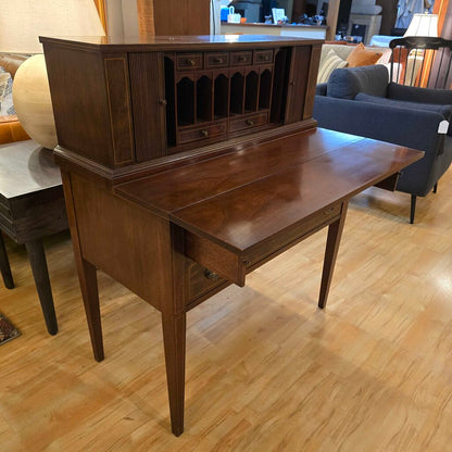 Wooden desk with cabinet in a room with furniture and decor
