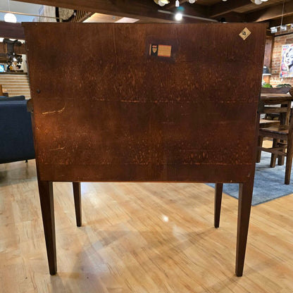 Brown wooden table with a checkered floor and blurred background