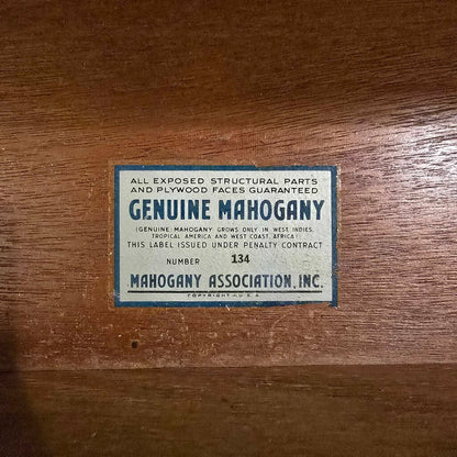 Genuine Mahogany label on a wooden surface