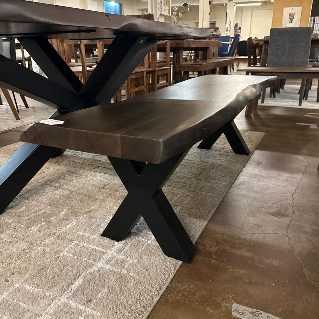 Wooden dining table with black metal legs in a showroom setting