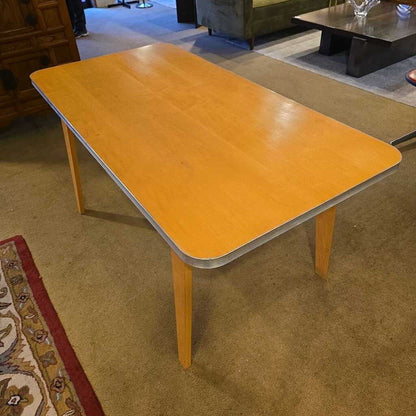 Yellow table in a room with carpeted floor and furniture.